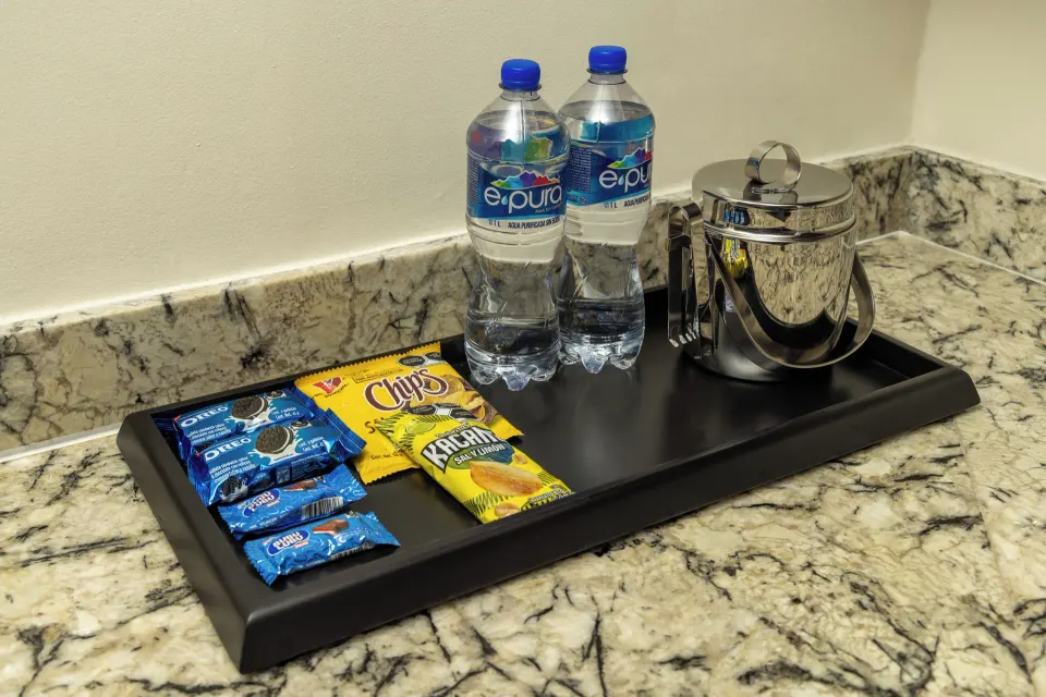Bottled water, snacks, and an ice bucket on a villa counter at Moon Palace Cancun.