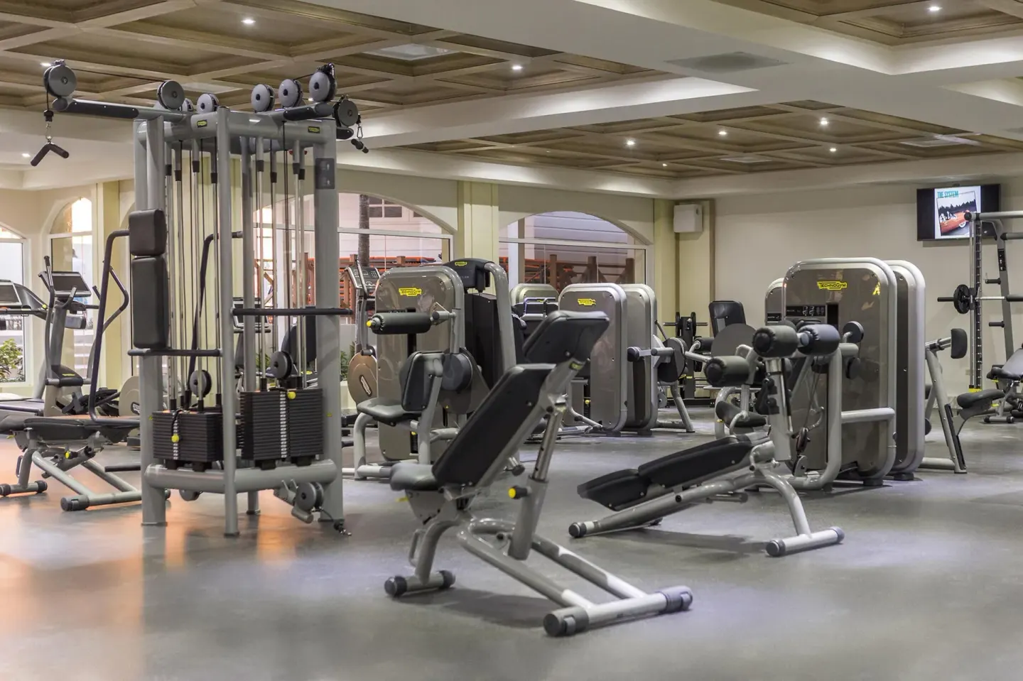 A fitness center with weight machines and benches at Moon Palace Jamaica.