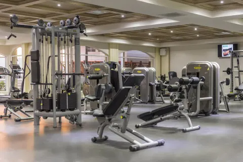 A fitness center with weight machines and benches at Moon Palace Jamaica.