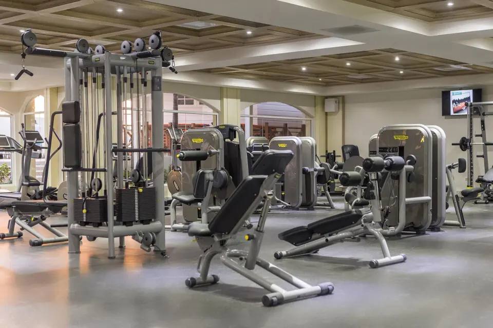 A fitness center with weight machines and benches at Moon Palace Jamaica.