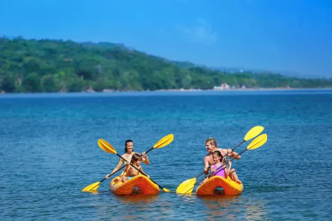 Guests kayak on calm blue water near Moon Palace Jamaica.