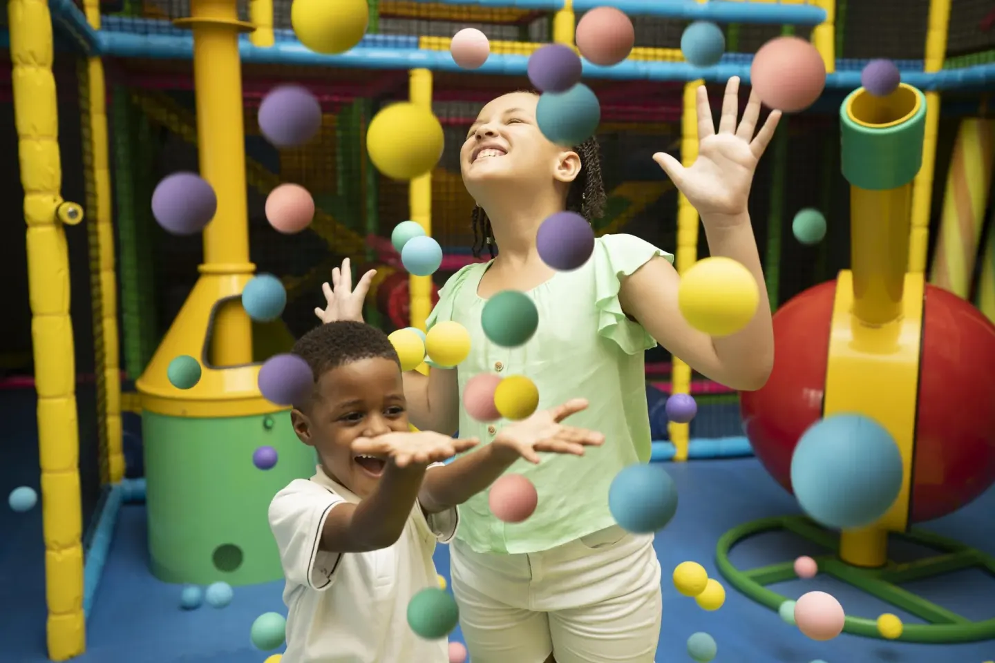 Children play with colorful floating balls in a kids' play area at Moon Palace Jamaica.