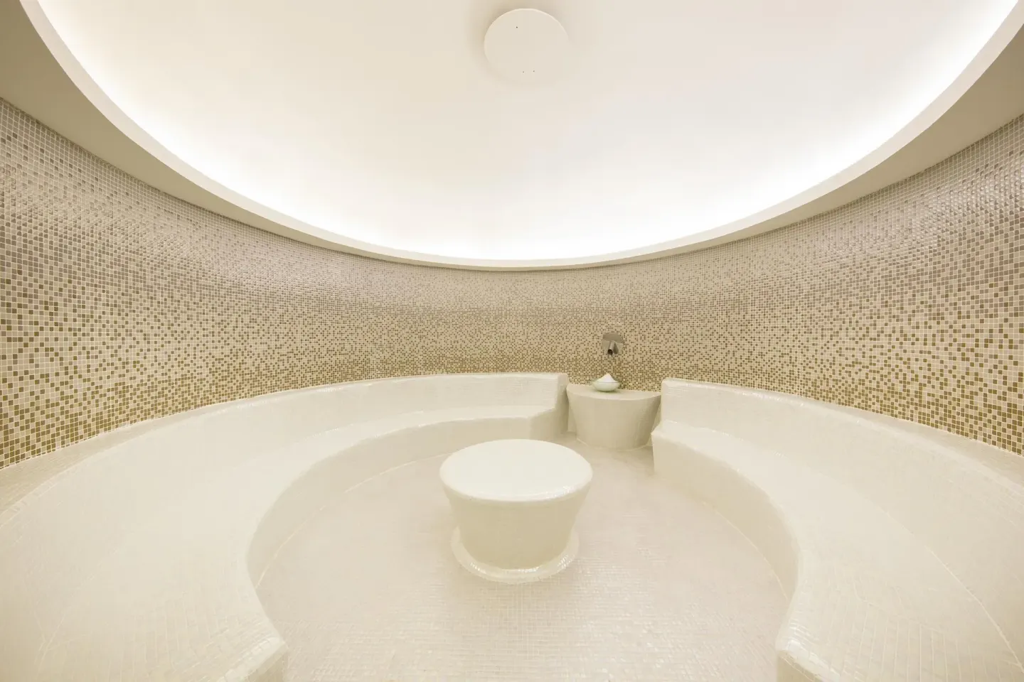 Curved mosaic steam room with tiled benches at Moon Palace Jamaica.