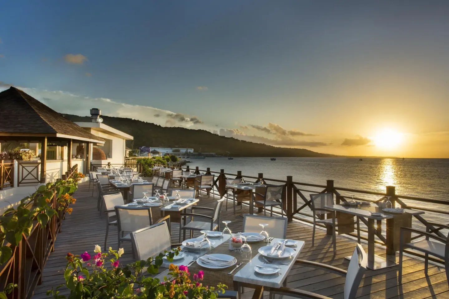 Oceanfront terrace set for dining at sunset at Moon Palace Jamaica.
