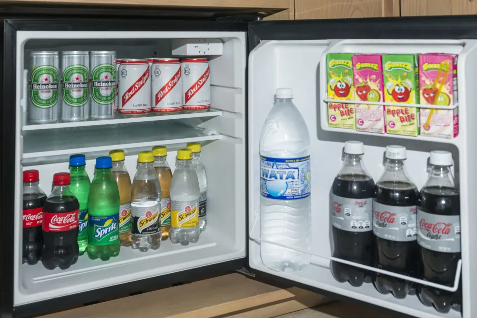Open guest room minibar stocked with drinks at Moon Palace Jamaica.