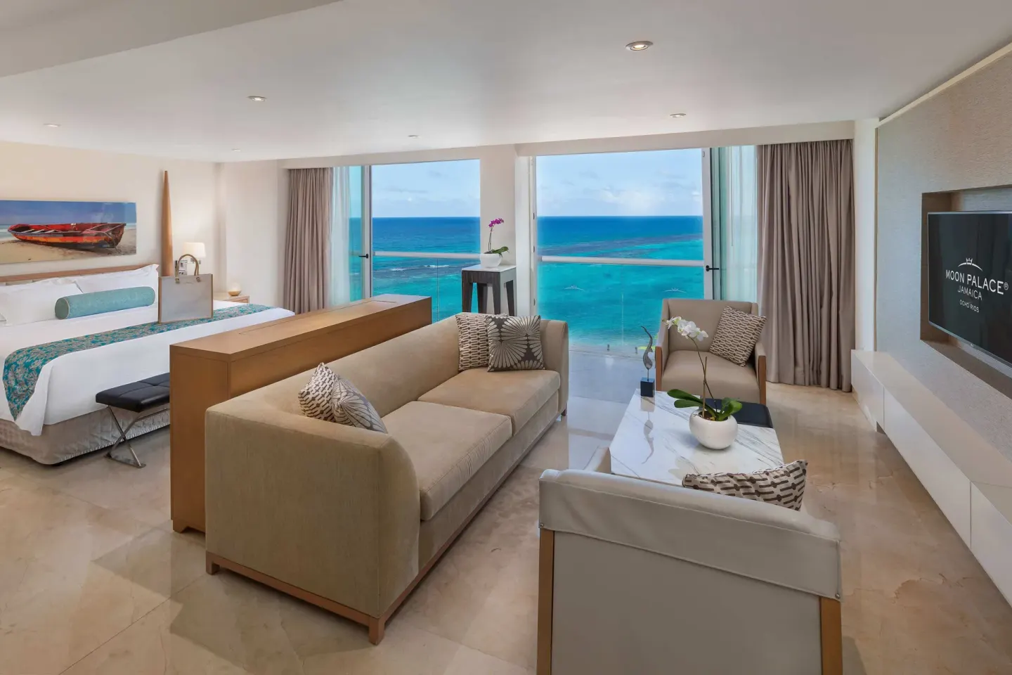 King bed and living area with ocean view in a presidential suite at Moon Palace Jamaica.