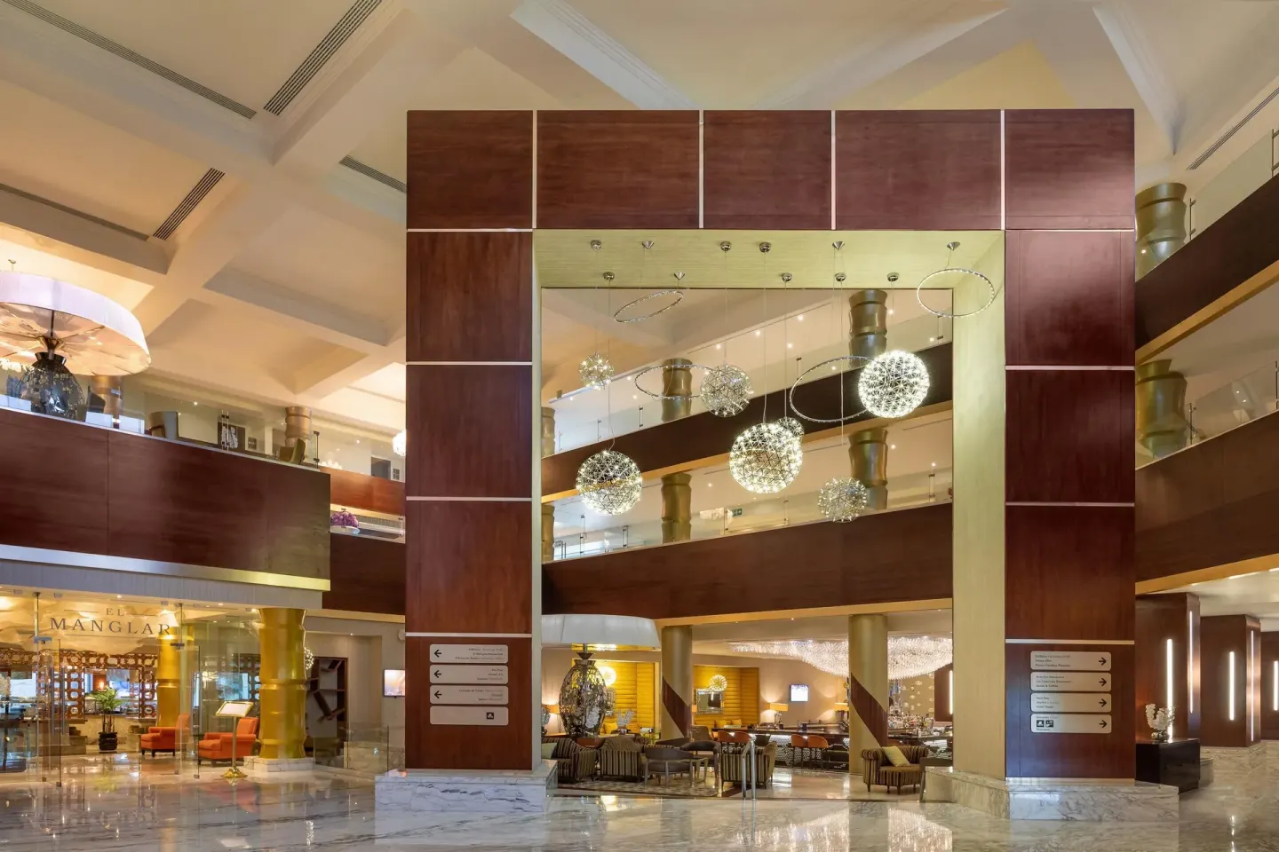 Atrium lobby with chandeliers and El Manglar entrance at Moon Palace Nizuc.