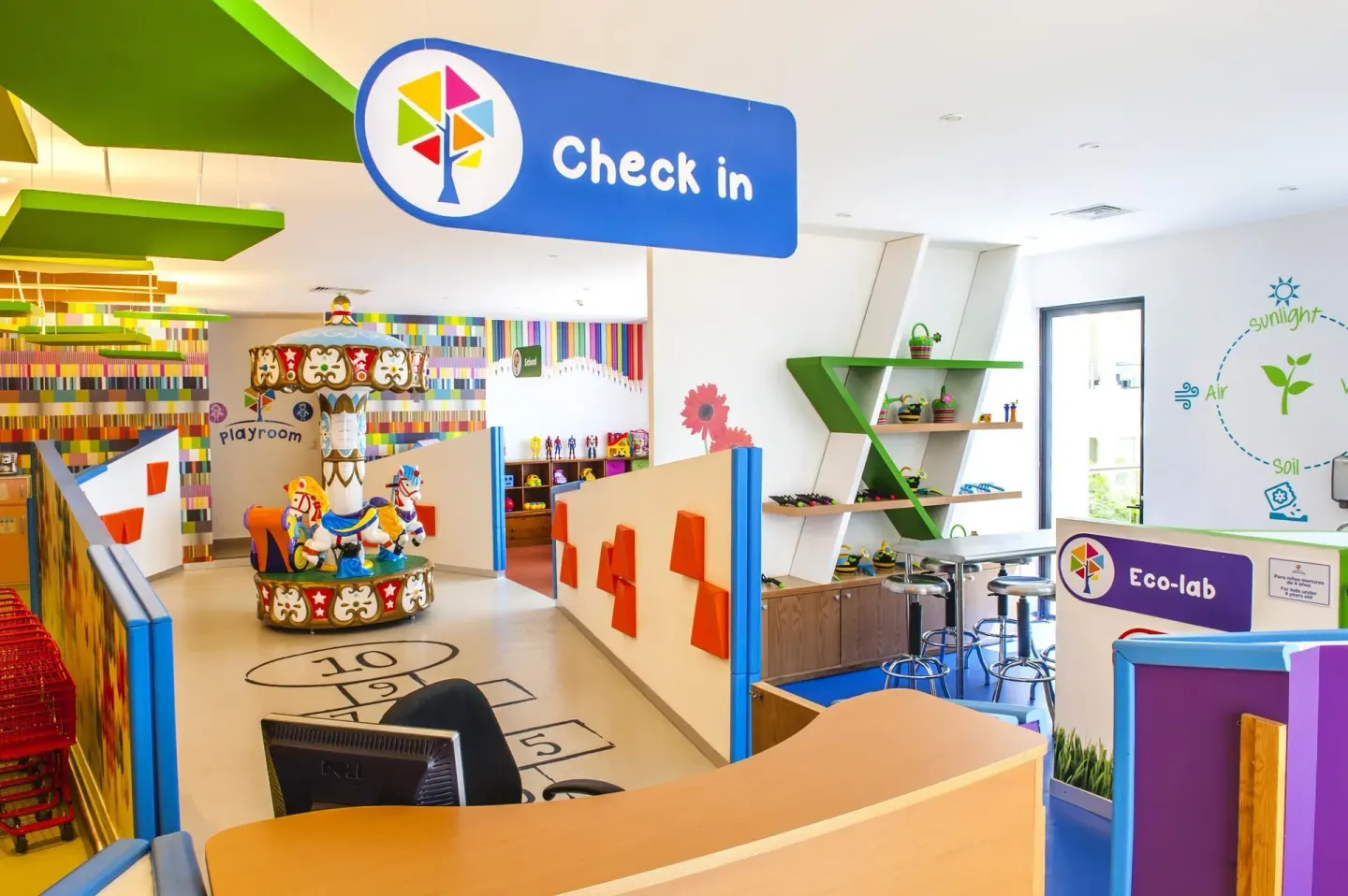 Kids club check-in desk with playroom and carousel at Moon Palace Nizuc.