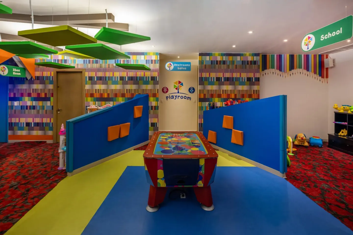 Kids club playroom with an air hockey table and school sign at Moon Palace Nizuc.