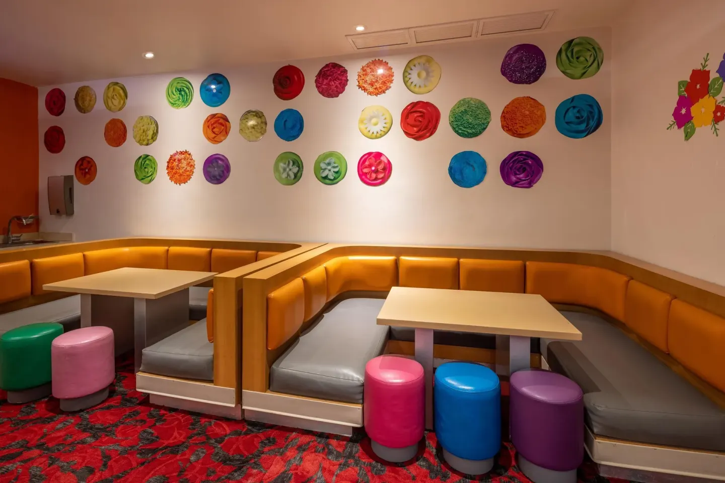 Children’s seating nook with colorful stools and wall art at Moon Palace Nizuc.