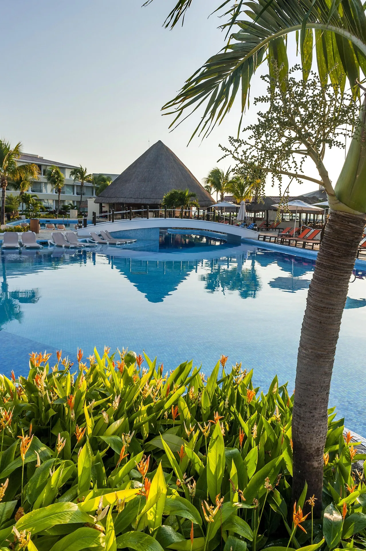 Pool with tropical plants and thatched pavilion at Moon Palace Nizuc.