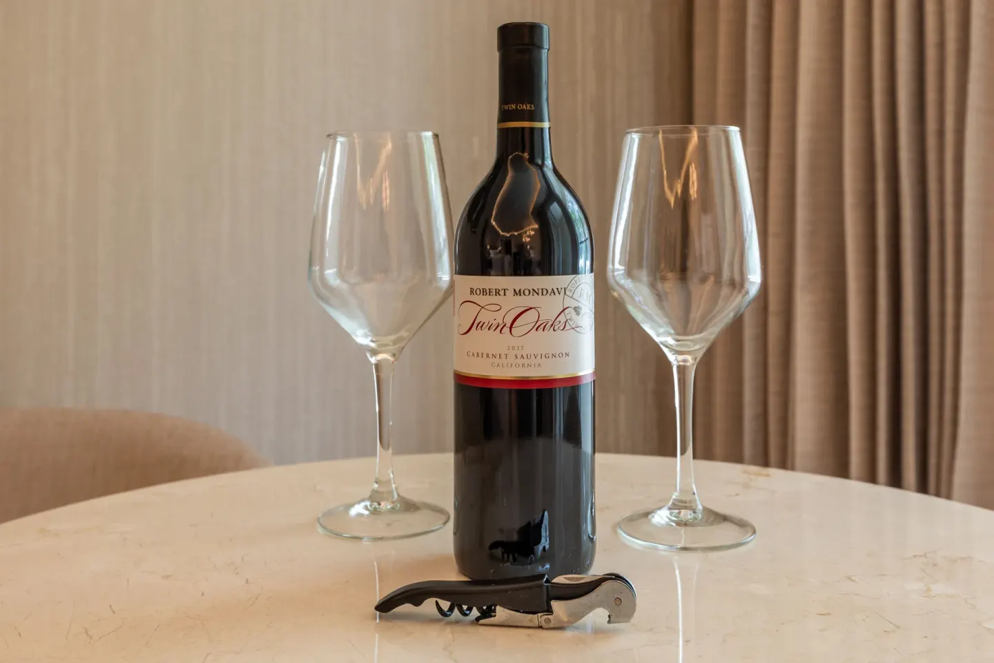 Wine bottle with two glasses on a room table at Moon Palace Nizuc.