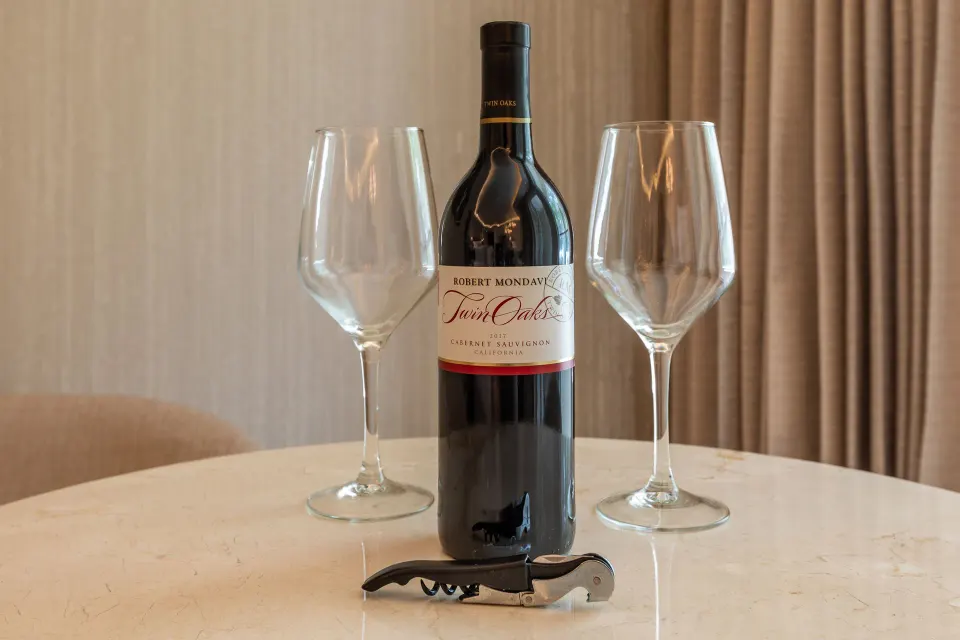 Wine bottle with two glasses on a room table at Moon Palace Nizuc.