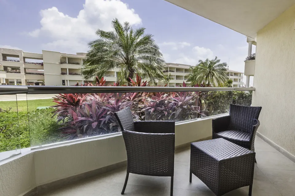 Garden-view balcony with wicker chairs at Moon Palace Nizuc.