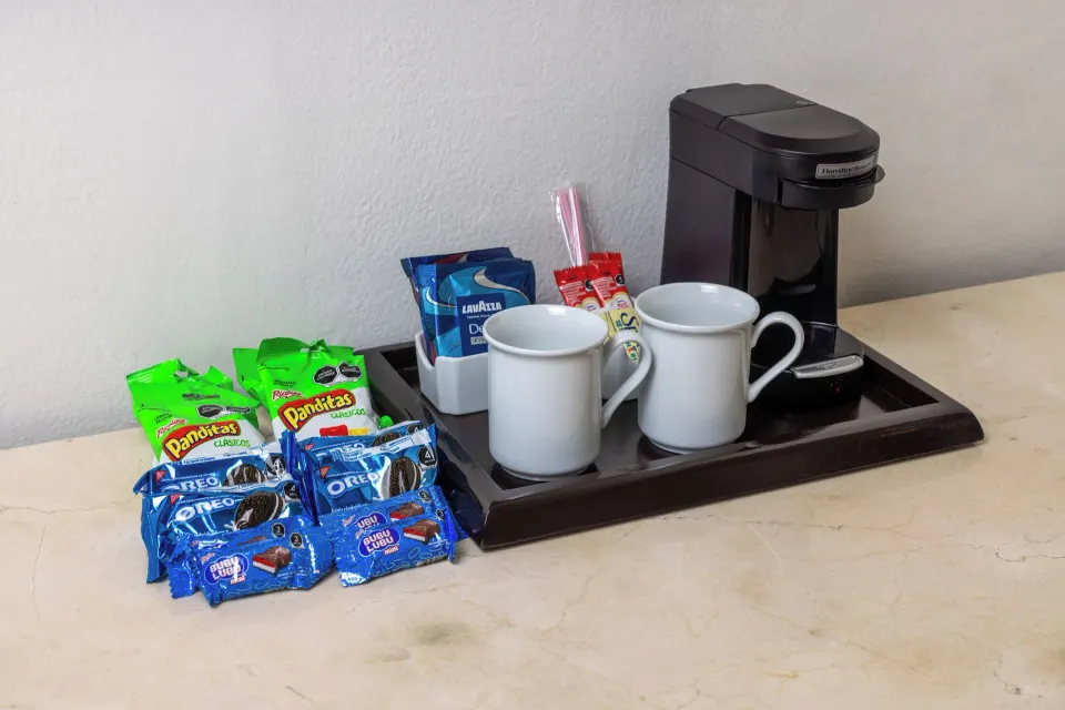 In-room coffee setup with mugs and snacks at Moon Palace Nizuc.