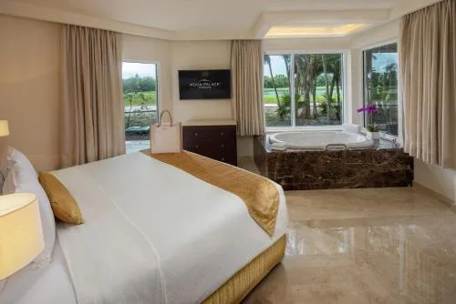 Suite bedroom with king bed and window-side soaking tub at Moon Palace Nizuc.