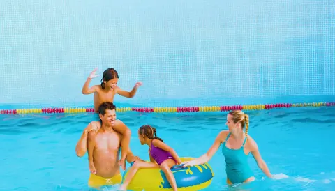 Family playing with an inner tube in the pool at Moon Palace The Grand Cancun.