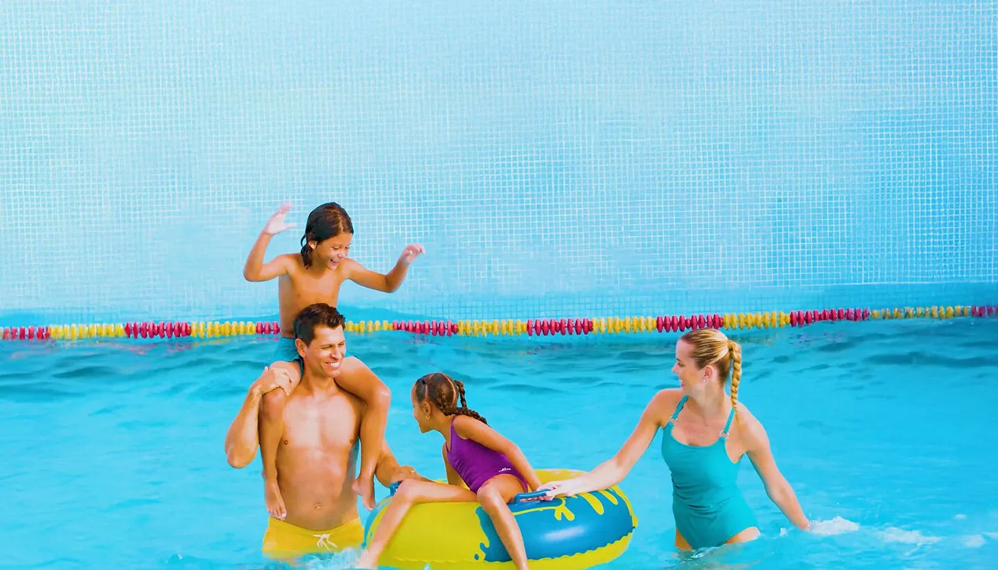 Family playing with an inner tube in the pool at Moon Palace The Grand Cancun.