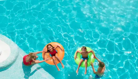 Children floating in pool rings with adults nearby at Moon Palace The Grand Cancun.
