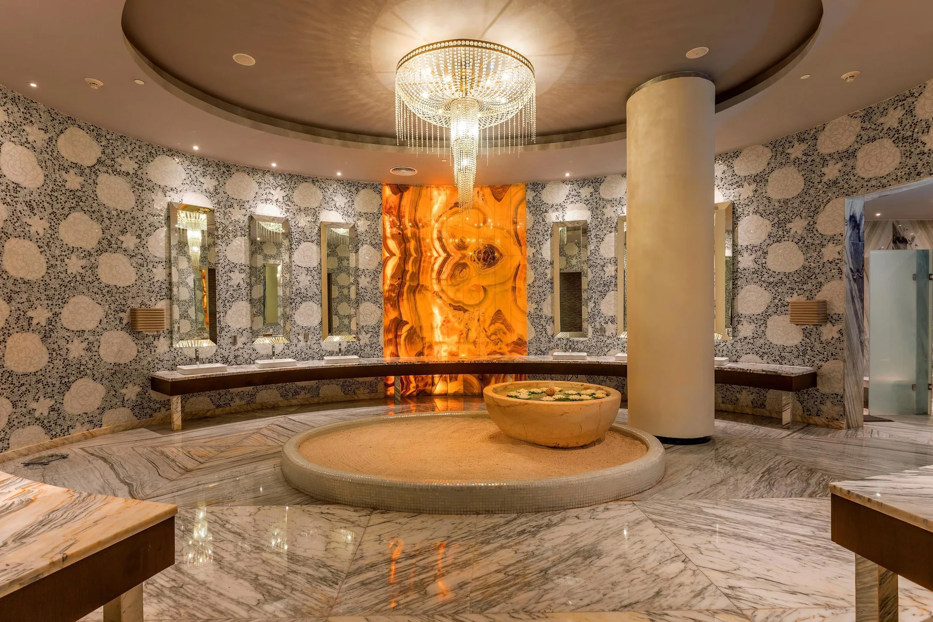 Round spa changing area with sinks, chandelier and marble floors at Moon Palace The Grand Cancun.