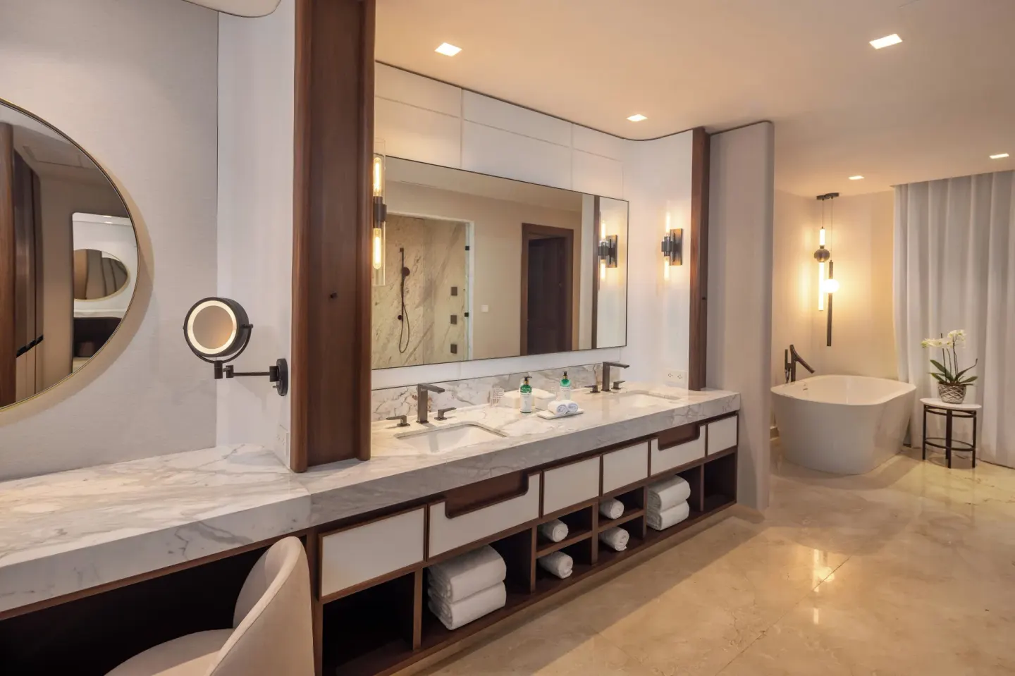 Marble bathroom with double vanity and freestanding tub at Moon Palace The Grand Cancun.