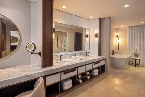 Marble bathroom with double vanity and freestanding tub at Moon Palace The Grand Cancun.