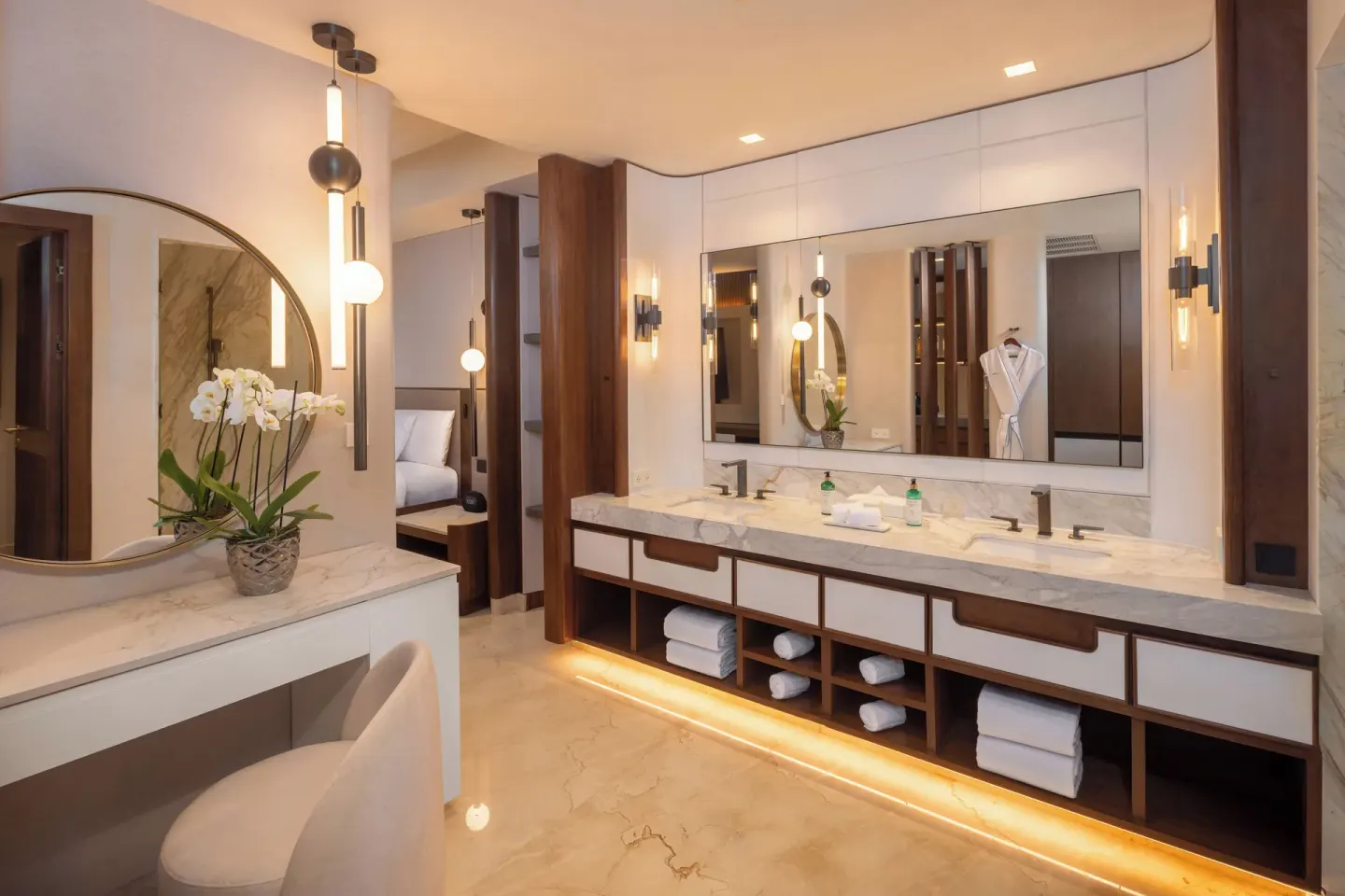 Bright suite bathroom vanity with round mirror at Moon Palace The Grand Cancun.