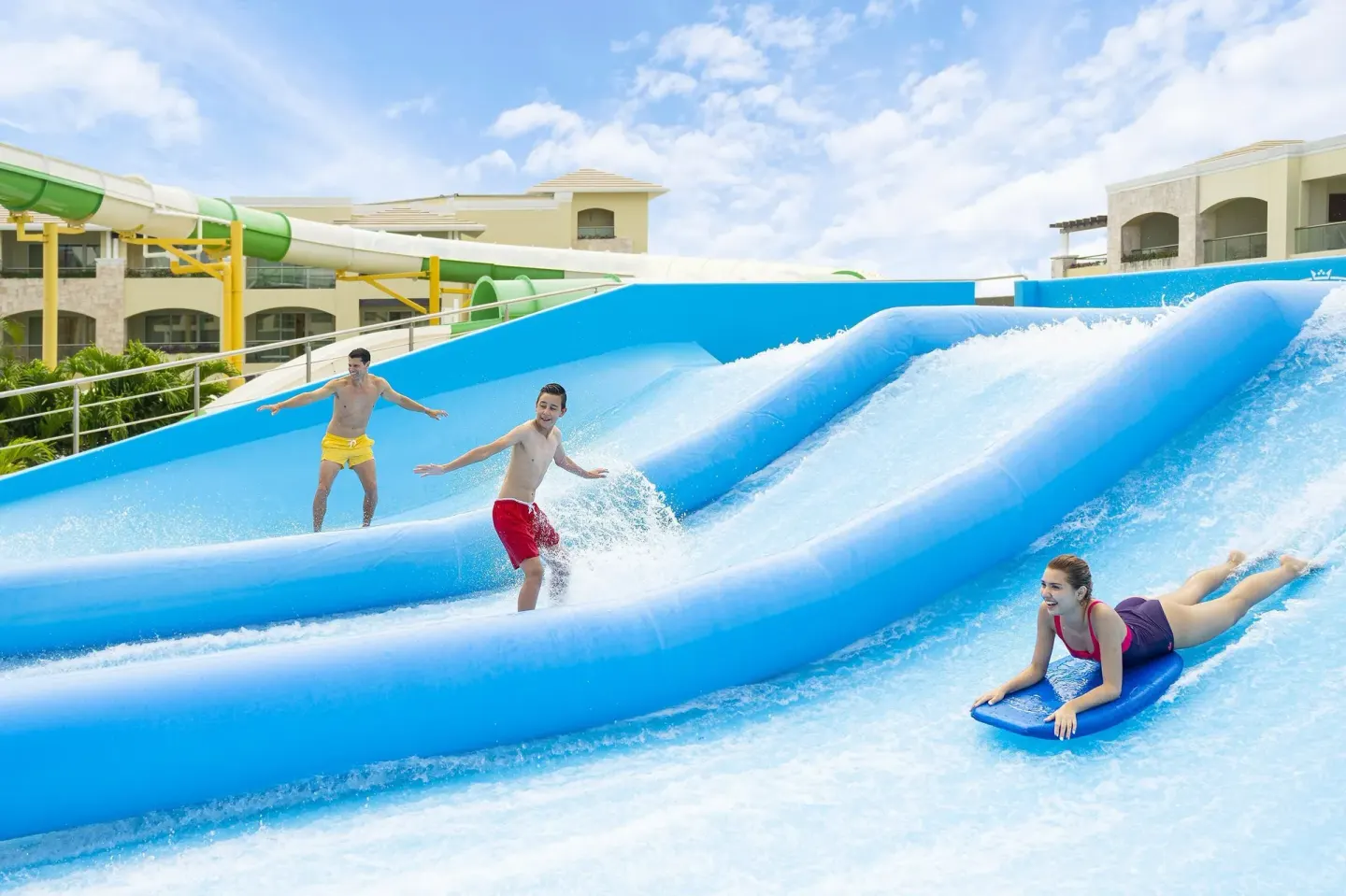 Guests ride a surf-style water attraction at Moon Palace The Grand Cancun.