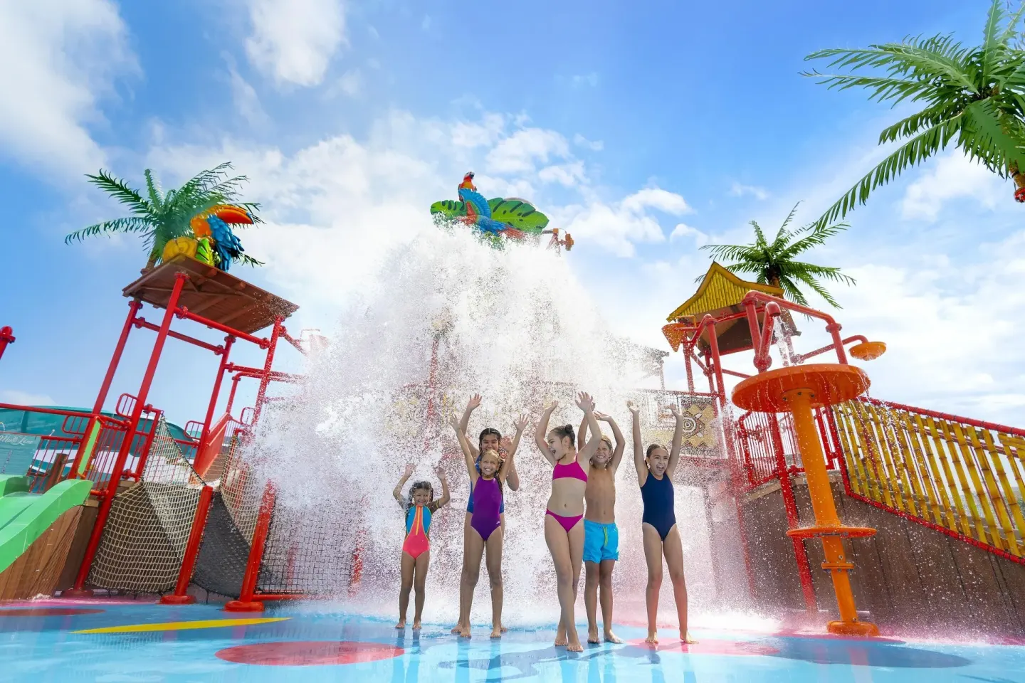 Children play under a splash bucket at the water park at Moon Palace The Grand Cancun.