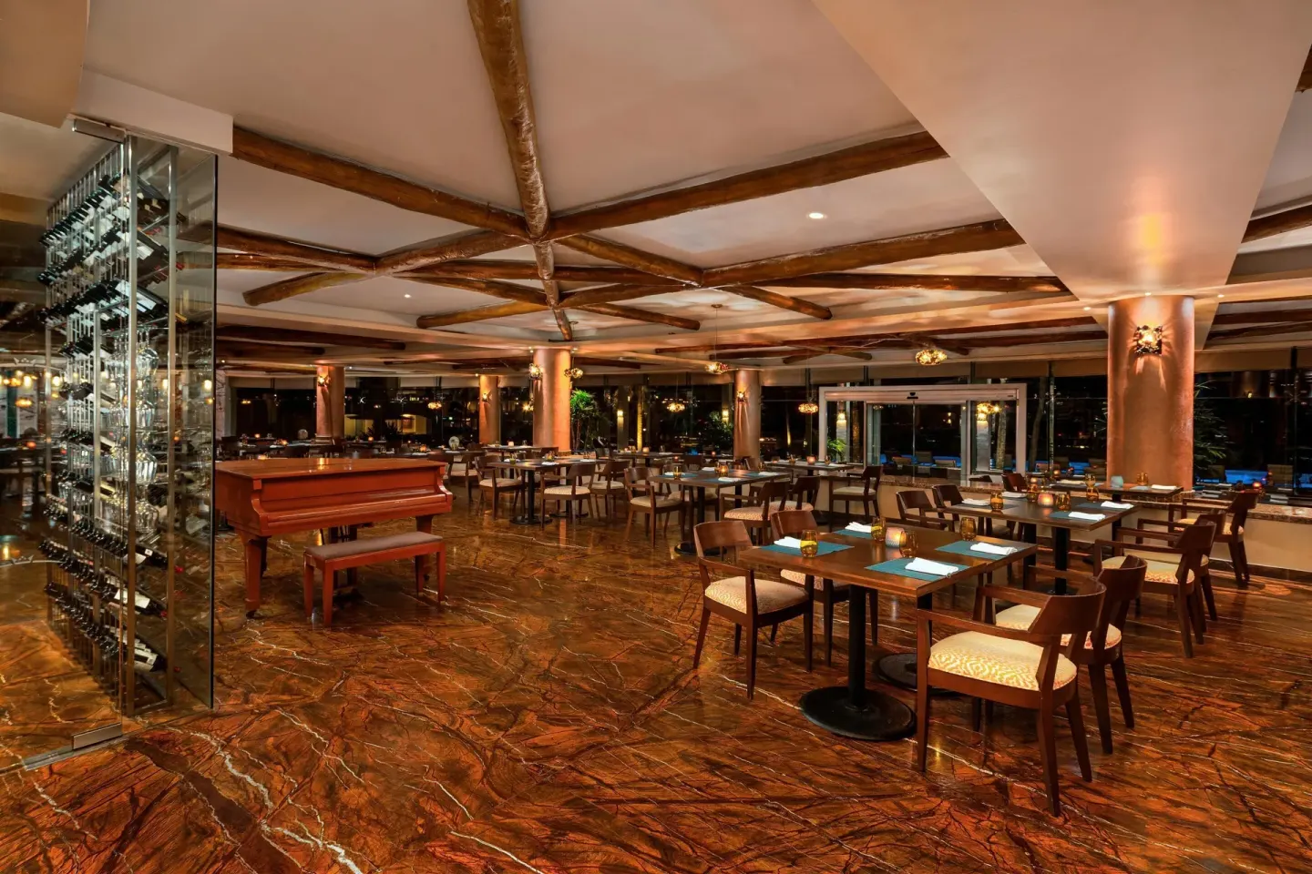 Large restaurant dining room with piano at Moon Palace The Grand Cancun.