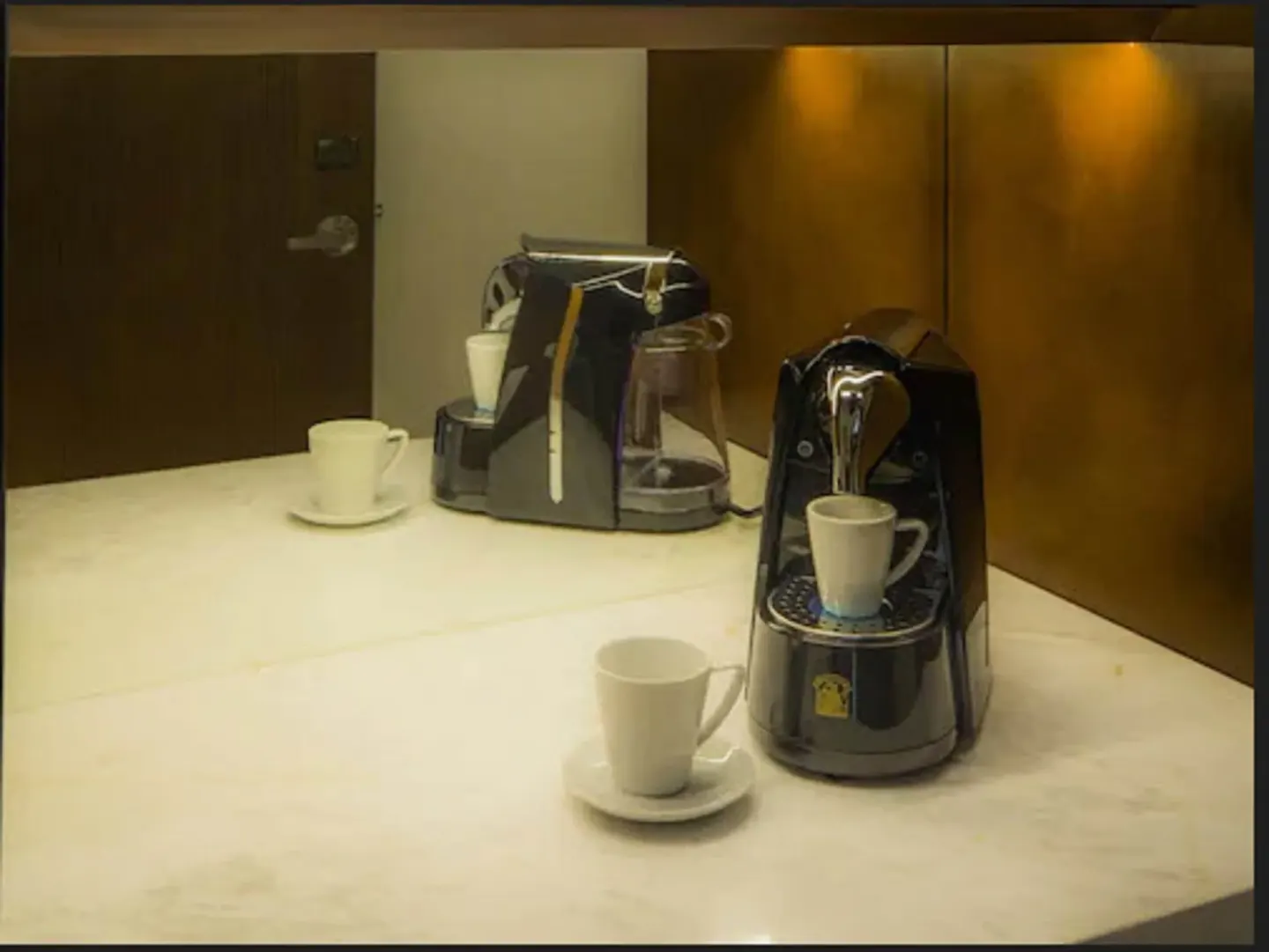 Coffee machines and cups on a room counter at Moon Palace The Grand Cancun.