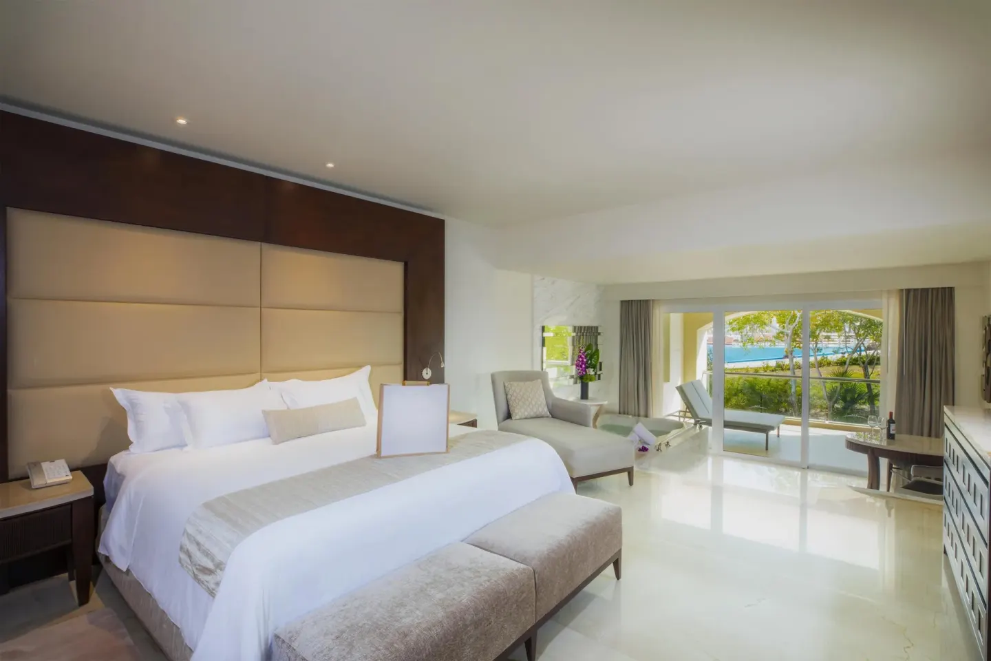 Grand Governor Suite king bed facing balcony doors at Moon Palace The Grand Cancun.