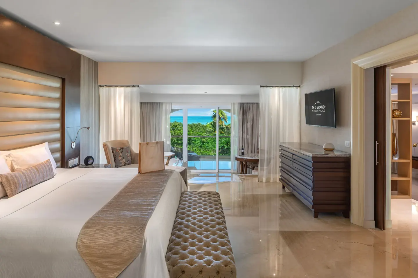 Grand Presidential Suite king bedroom at Moon Palace The Grand Cancun with balcony doors and dresser.