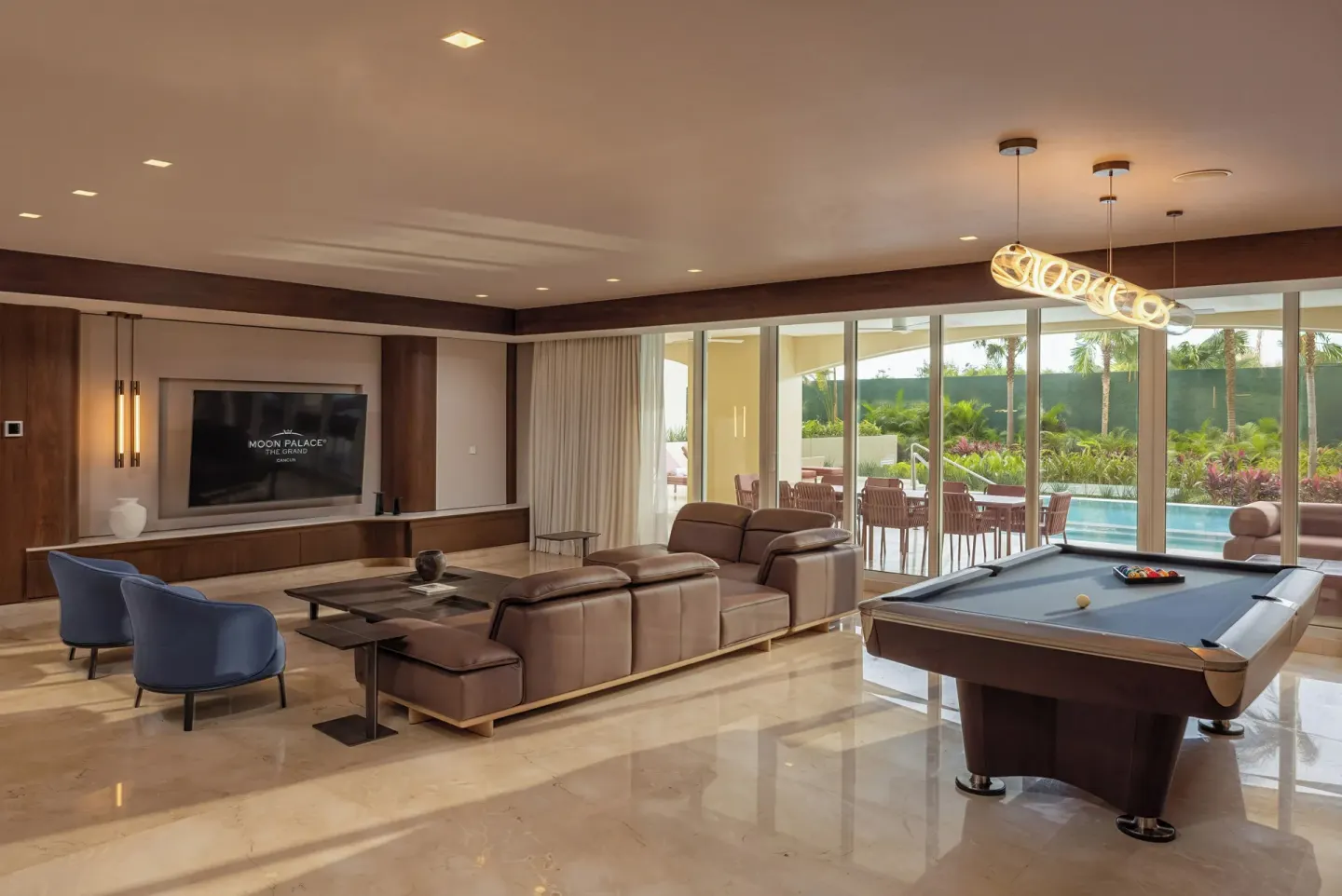 Grand Villa Pool Three Bedroom living room at Moon Palace The Grand Cancun with pool table and pool view.