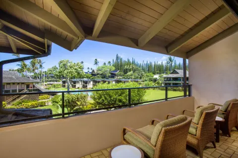 Covered lanai with chairs overlooking resort grounds at Napili Kai Beach Resort.