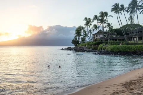 Sunset over the beach and shoreline at Napili Kai Beach Resort.