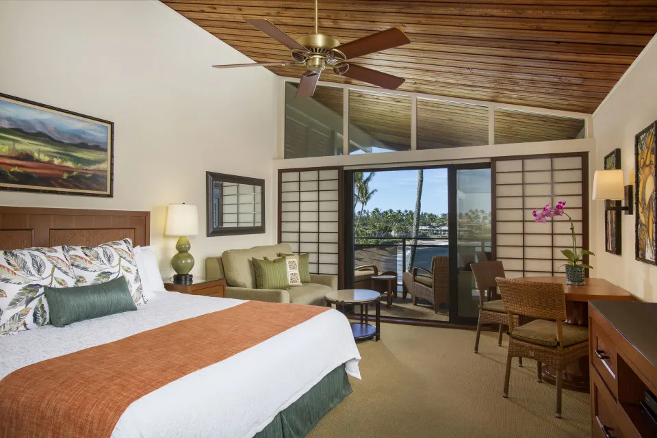 Deluxe Room with king bed, seating area, and balcony at Napili Kai Beach Resort.