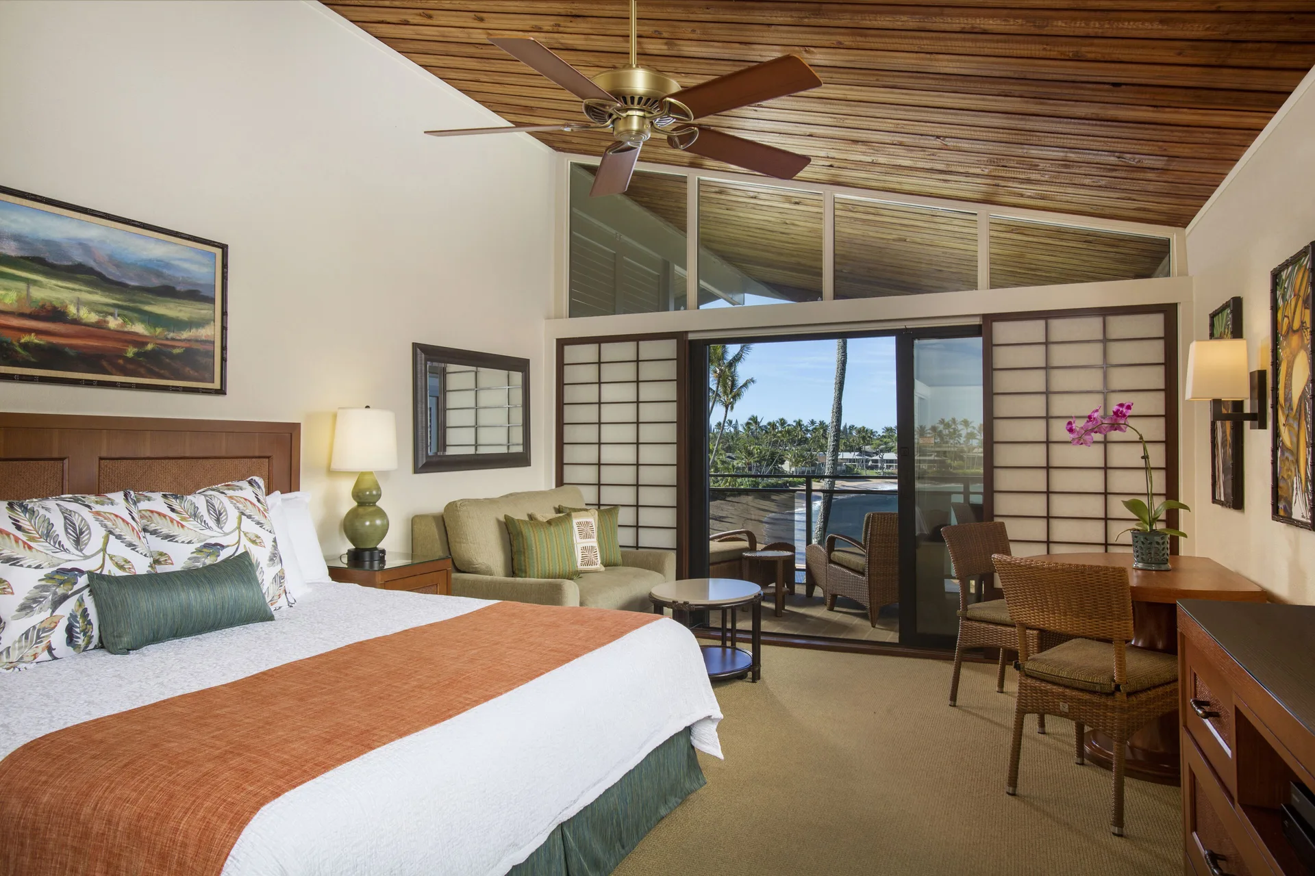 Deluxe Room with king bed, seating area, and balcony at Napili Kai Beach Resort.