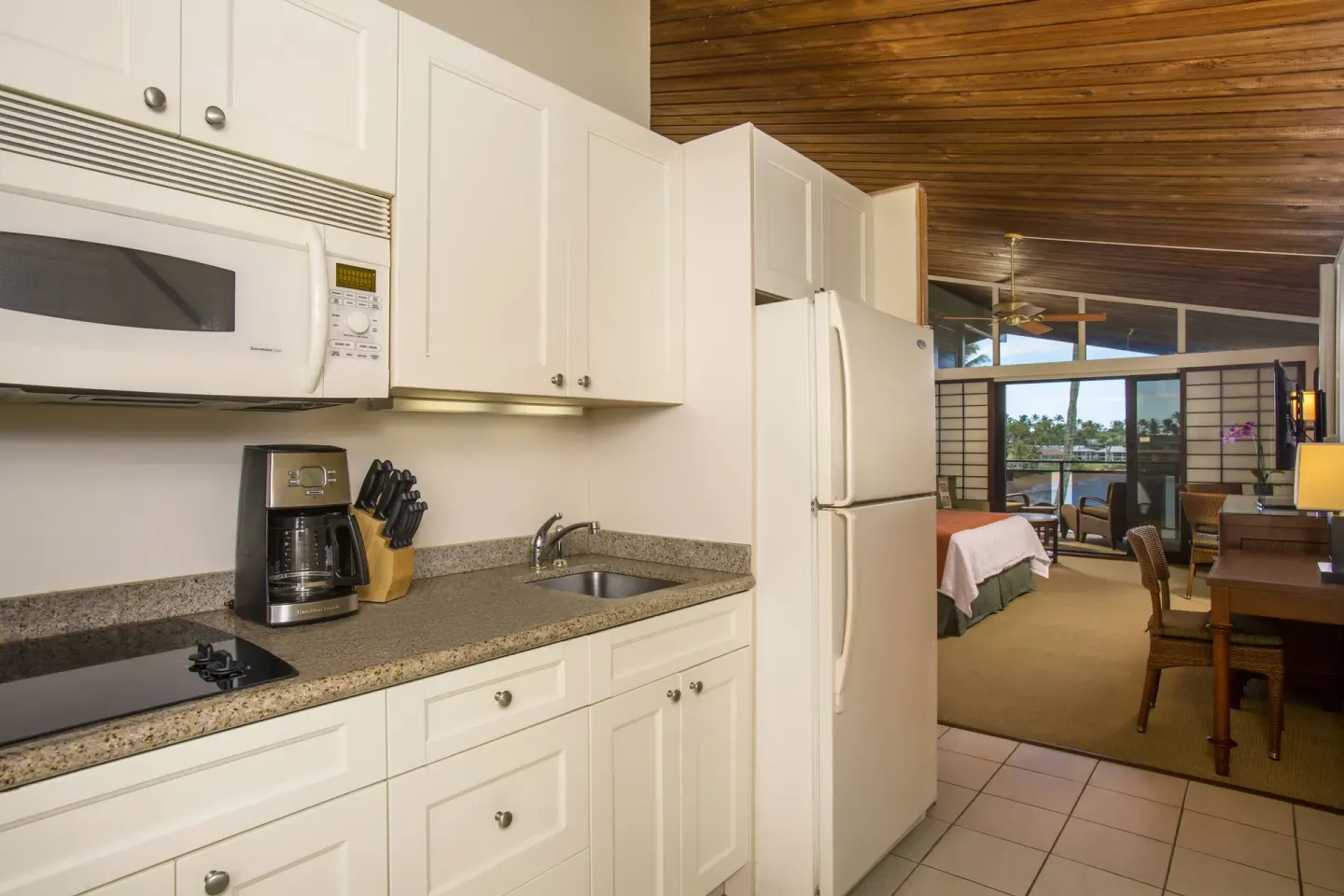 Deluxe Room kitchenette with refrigerator and room beyond at Napili Kai Beach Resort.