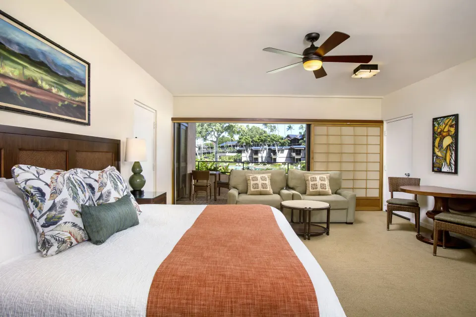 Family Studio Garden View room with bed, sofa and lanai at Napili Kai Beach Resort.