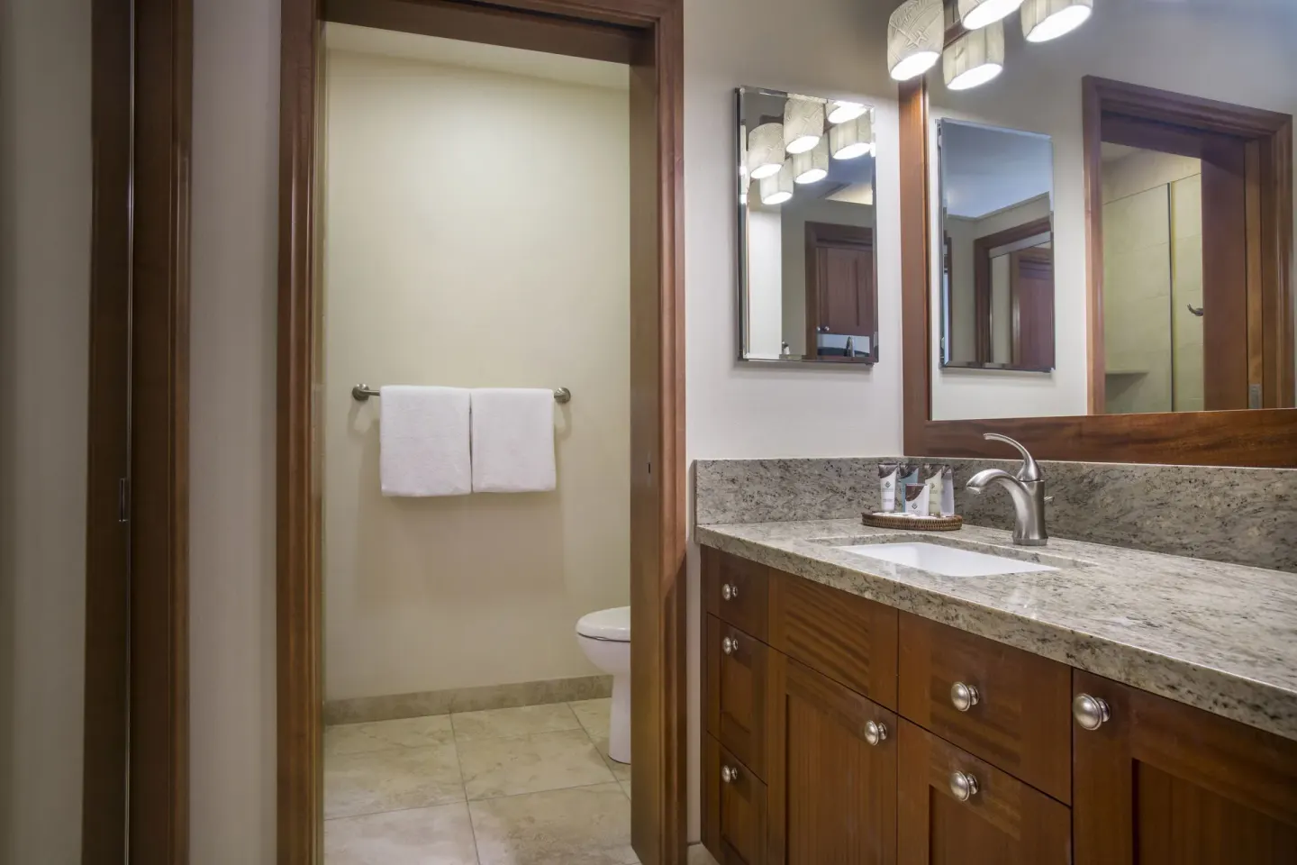 Suite bathroom vanity with granite counter and mirrors at Napili Kai Beach Resort.