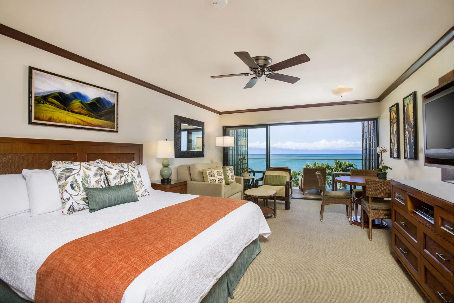 Oceanfront one-bedroom suite with king bed and balcony view at Napili Kai Beach Resort.