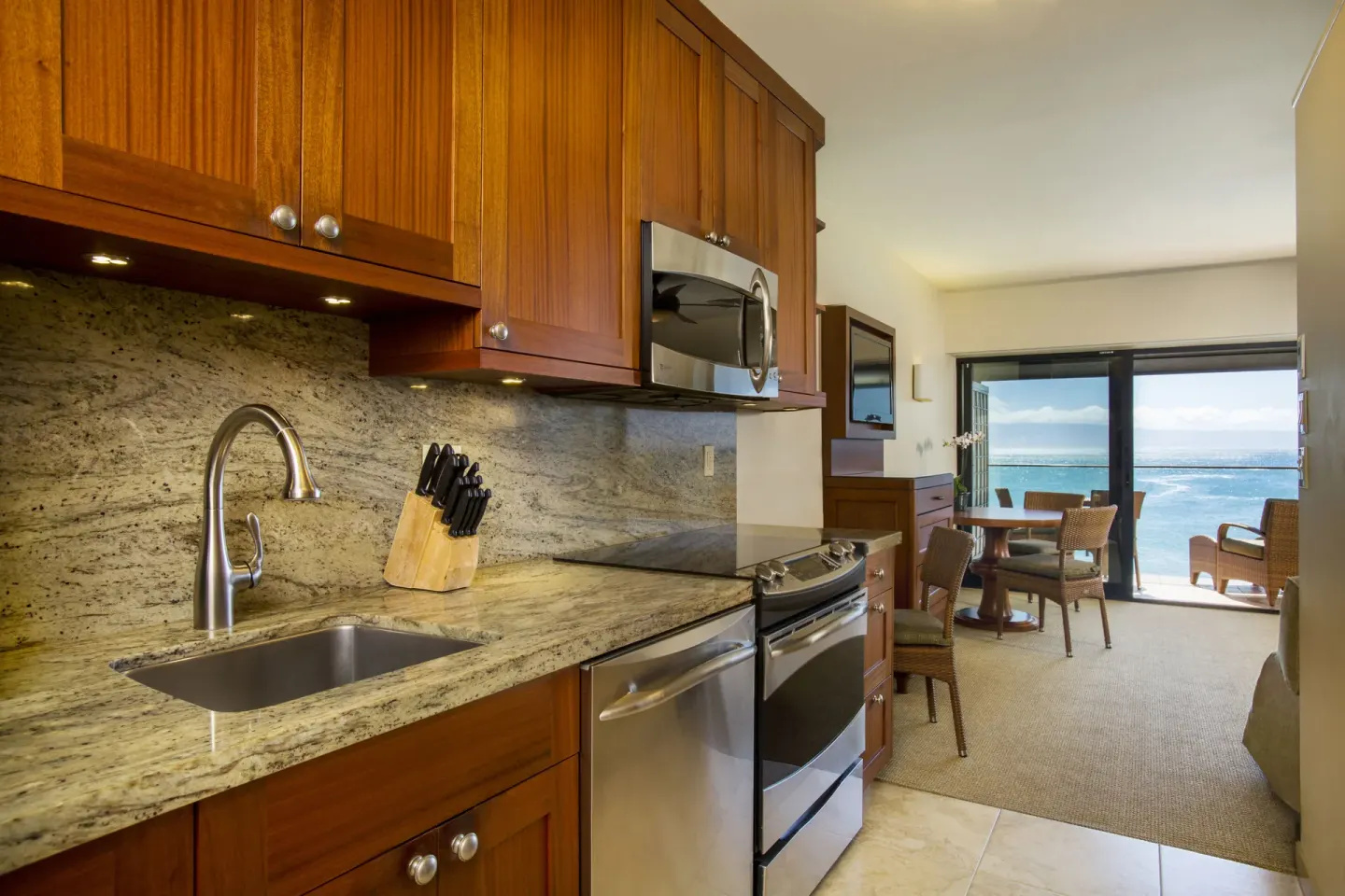 Oceanfront suite kitchen with ocean view through the living area at Napili Kai Beach Resort.