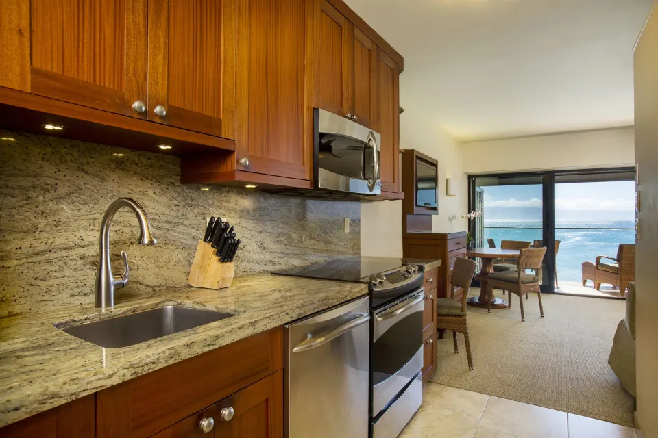 Oceanfront suite kitchen with ocean view through the living area at Napili Kai Beach Resort.