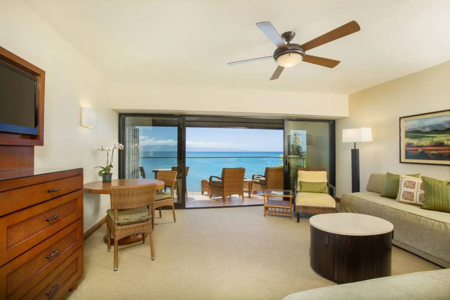 Oceanfront suite living area with sofa and balcony seating at Napili Kai Beach Resort.