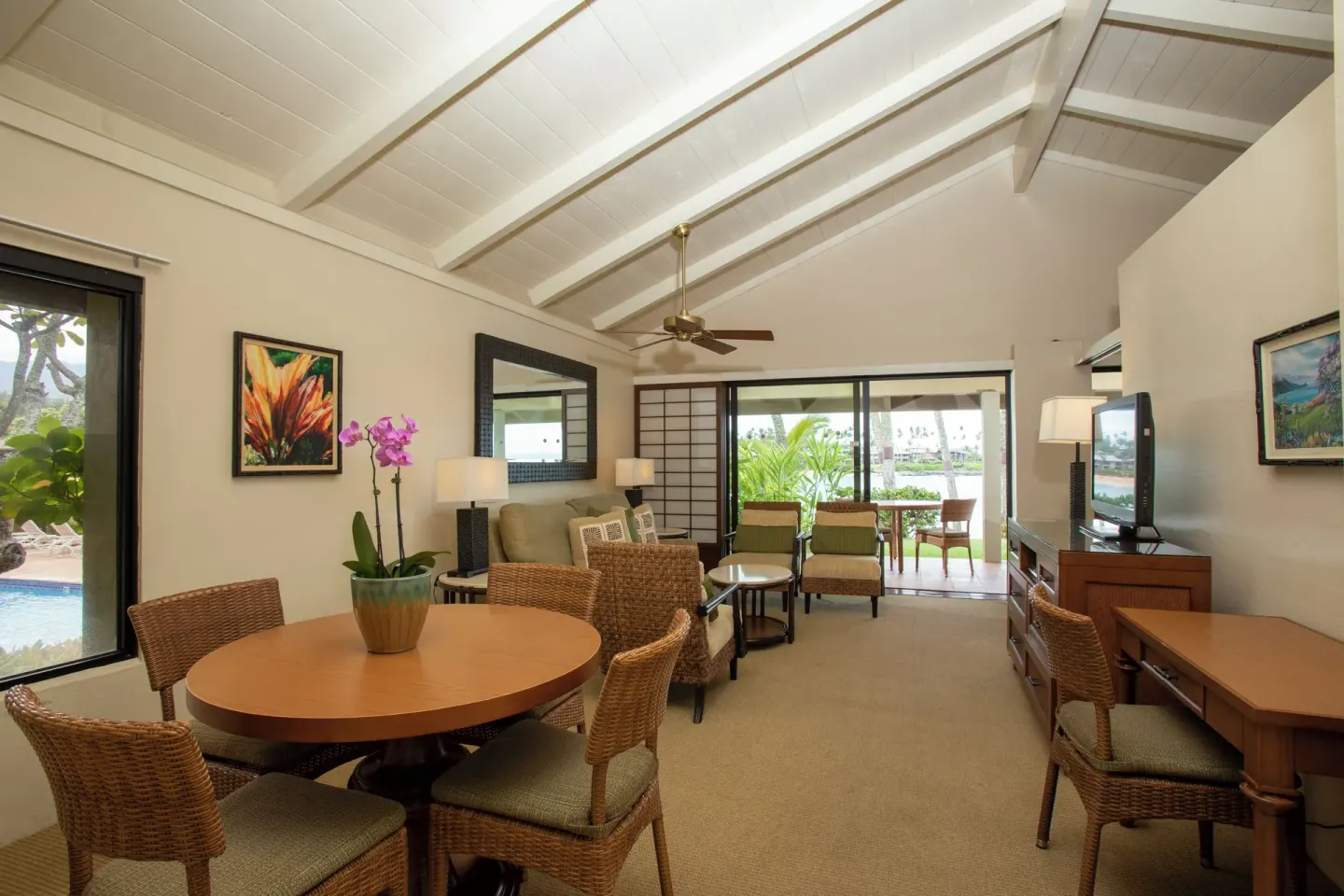 Oceanfront suite living and dining room at Napili Kai Beach Resort with lanai beyond sliding doors.