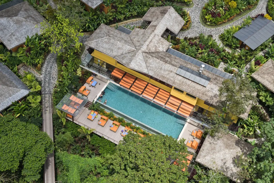 Aerial view of the resort pool surrounded by greenery at Nayara Springs.