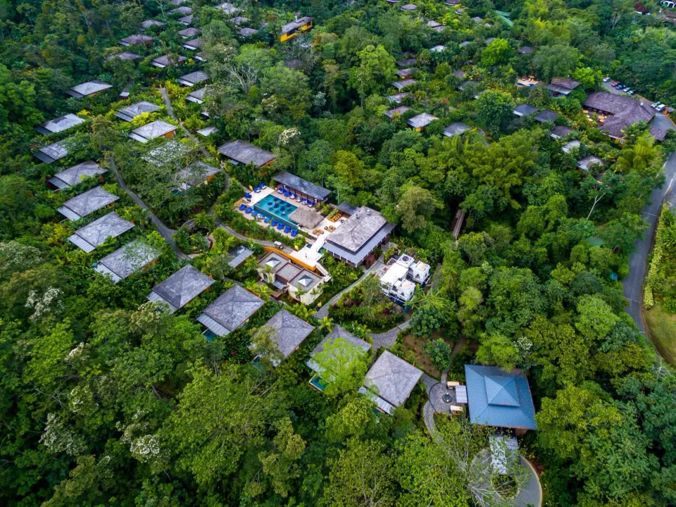 Aerial view of Nayara Springs villas, pool, and rainforest grounds.