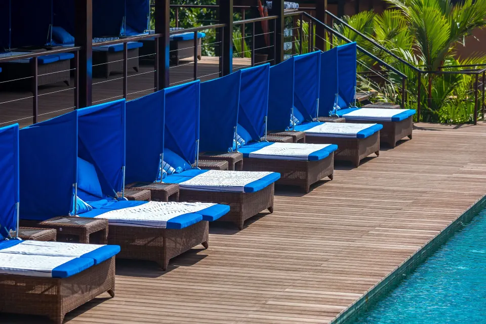 Blue cushioned loungers line the pool deck at Nayara Springs.