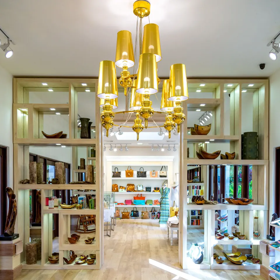 A boutique display room with shelves and a gold chandelier is shown at Nayara Springs.